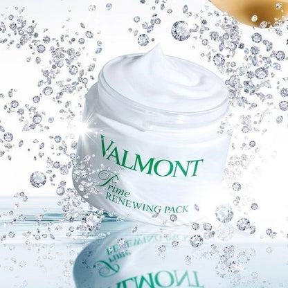 Open Valmont Prime Renewing Pack jar with visible cream inside, surrounded by small diamonds on a styled surface.