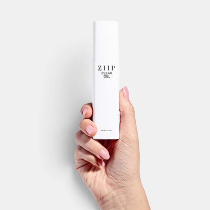 ZIIP Clear Gel bottle held in a hand against a white background