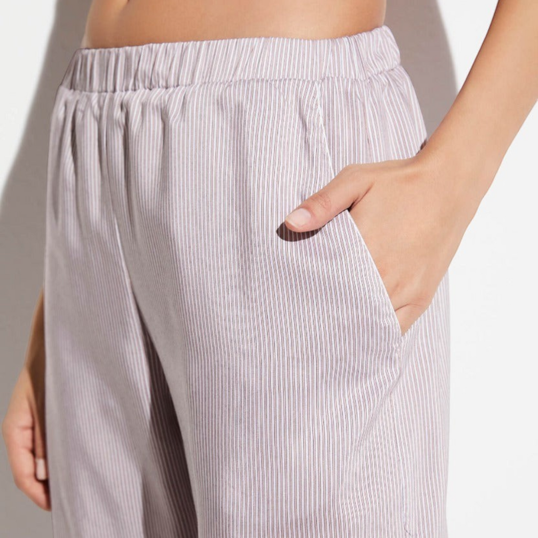 Shop Rescue Spa long pants in sand with fine vertical stripes, featuring an elastic waistband and side pockets.